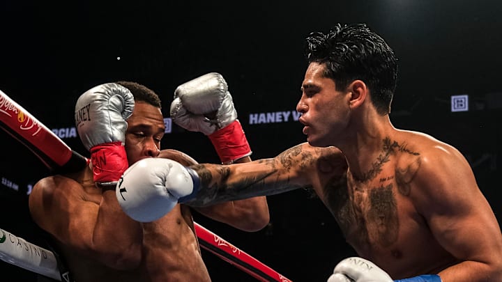 Ryan Garcia throws a right hand against Devin Haney.