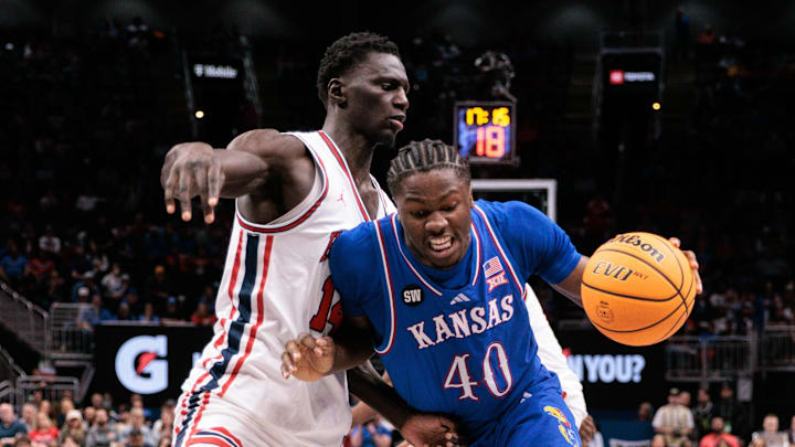 Mar 13, 2026; Kansas City, MO, USA; Kansas Jayhawks forward Flory Bidunga (40) drives to the basket around Houston Cougars forward Kalifa Sakho (14) during the second half at T-Mobile Center. Mandatory Credit: William Purnell-Imagn Images