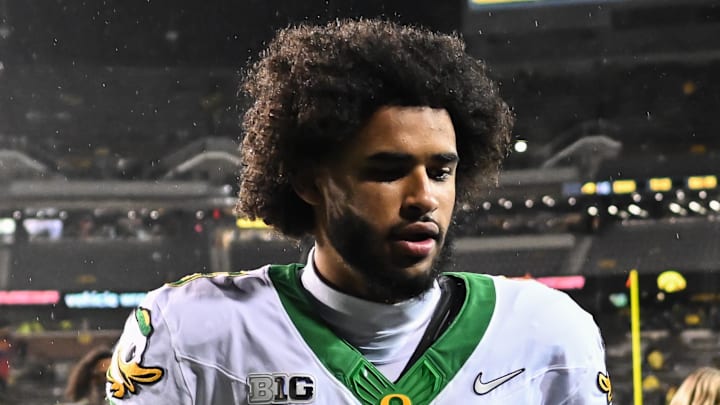 Nov 8, 2025; Iowa City, Iowa, USA; Oregon Ducks quarterback Dante Moore (5) runs off the field after the game against the Iowa Hawkeyes at Kinnick Stadium. Mandatory Credit: Jeffrey Becker-Imagn Images