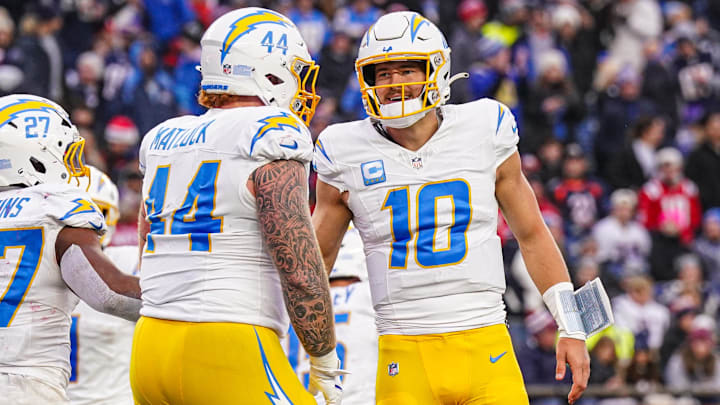 Dec 28, 2024; Foxborough, Massachusetts, USA; Los Angeles Chargers quarterback Justin Herbert (10) reacts after running back J.K. Dobbins (27) scores against the New England Patriots in the second half at Gillette Stadium. Mandatory Credit: David Butler II-Imagn Images