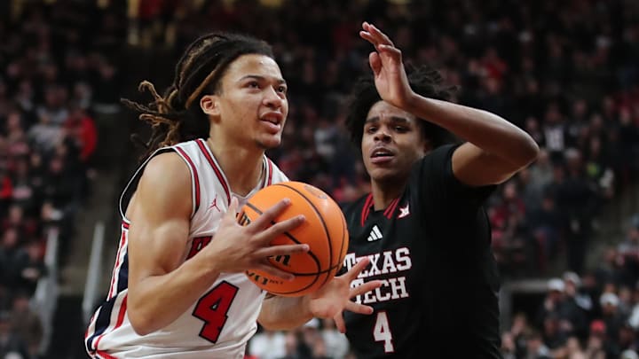 Jan 24, 2026; Lubbock, Texas, USA;  Houston Cougars guard Kingston Flemings (4) drives the lane against Texas Tech Red Raiders guard Christian Anderson (4) in the second half at United Supermarkets Arena. Mandatory Credit: Michael C. Johnson-Imagn Images
