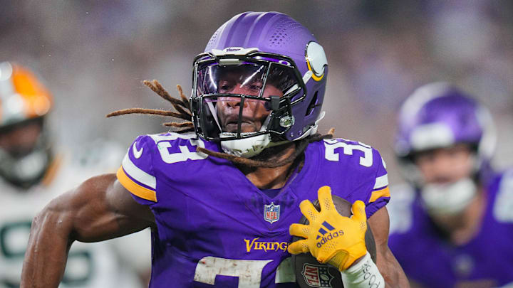 Dec 29, 2024; Minneapolis, Minnesota, USA; Minnesota Vikings running back Aaron Jones (33) runs with the ball against Green Bay Packers in the third quarter at U.S. Bank Stadium. Mandatory Credit: Brad Rempel-Imagn Images