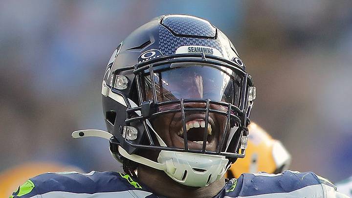 Former Seattle Seahawks linebacker Jamie Sheriff celebrates a sack