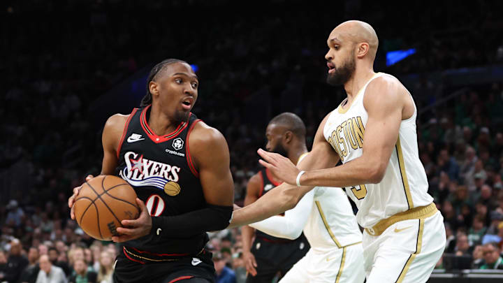 Mar 1, 2026; Boston, Massachusetts, USA; Philadelphia 76ers guard Tyrese Maxey (0) drives to the basket defended by Boston Celtics guard Derrick White (9) during the first half at TD Garden. Mandatory Credit: Paul Rutherford-Imagn Images