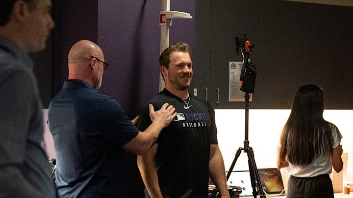 Colorado Rockies catcher Braxton Fulford gets his height measured by MLB strength and conditioning coach Jim Malone for the new ABS challenge system.