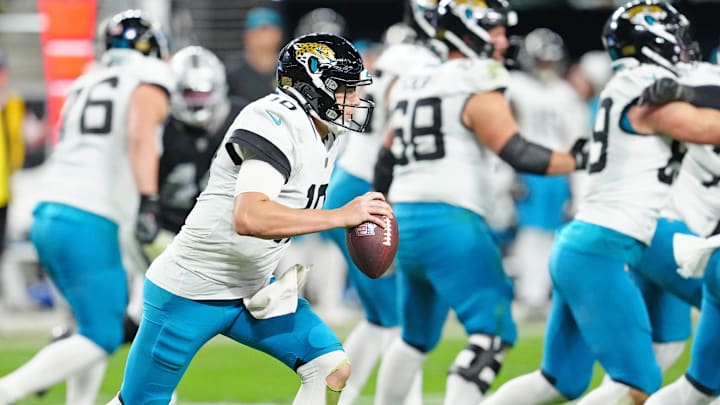 Dec 22, 2024; Paradise, Nevada, USA; Jacksonville Jaguars quarterback Mac Jones (10) gains yardage against the Las Vegas Raiders during the fourth quarter at Allegiant Stadium. Mandatory Credit: Stephen R. Sylvanie-Imagn Images