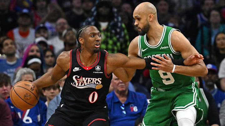 Apr 24, 2026; Philadelphia, Pennsylvania, USA; Philadelphia 76ers guard Tyrese Maxey (0) is defended by Boston Celtics guard Derrick White (9) during the first half at Xfinity Mobile Arena. Mandatory Credit: Eric Hartline-Imagn Images