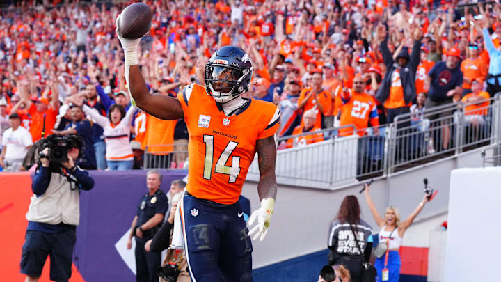 Oct 13, 2024; Denver, Colorado, USA; Denver Broncos wide receiver Courtland Sutton (14) celebrates his touchdown reception in the second half against the Los Angeles Chargers at Empower Field at Mile High. 