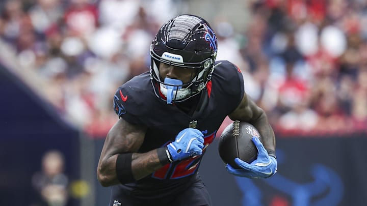 Oct 6, 2024; Houston, Texas, USA; Houston Texans wide receiver Nico Collins (12) runs with the ball after a reception during the first quarter against the Buffalo Bills at NRG Stadium. Mandatory Credit: Troy Taormina-Imagn Images