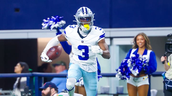 Dallas Cowboys wide receiver George Pickens reacts after making a catch over Philadelphia Eagles cornerback Cooper DeJean and Philadelphia Eagles safety Sydney Brown during the game at AT&T Stadium.