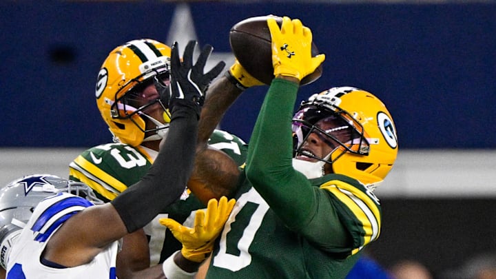 Green Bay Packers wide receiver Matthew Golden (0) catches a pass over Dallas Cowboys cornerback DaRon Bland. Green Bay Packers wide receiver Matthew Golden (0) catches a pass over Dallas Cowboys cornerback DaRon Bland.
