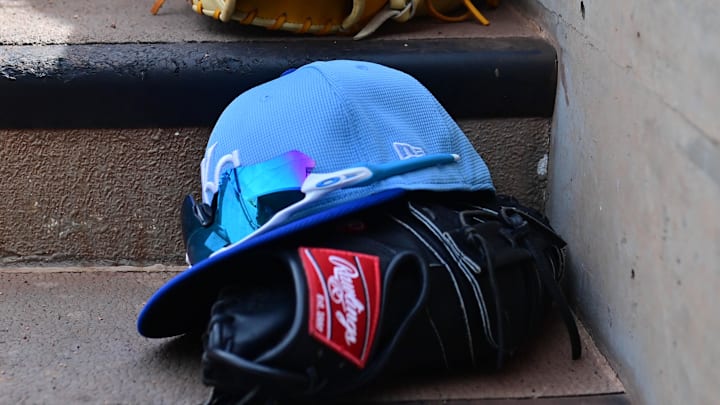 Mar 12, 2024; Salt River Pima-Maricopa, Arizona, USA;  General view of Kansas City Royals hats and gloves in the first inning against the Colorado Rockies during a spring training game at Salt River Fields at Talking Stick. 