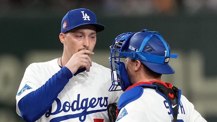 Mar 16, 2025; Bunkyo, Tokyo, Japan; Los Angeles Dodgers starting pitcher Blake Snell (7) talks with catcher Will Smith (right) during the fourth inning against the Hanshin Tigers at Tokyo Dome. 