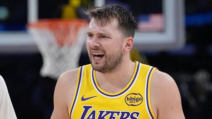 Jan 15, 2026; Los Angeles, California, USA; Los Angeles Lakers forward Jake LaRavia (12) and guard Luka Doncic (77) react against the Charlotte Hornets in the second half at Crypto.com Arena. Mandatory Credit: Kirby Lee-Imagn Images