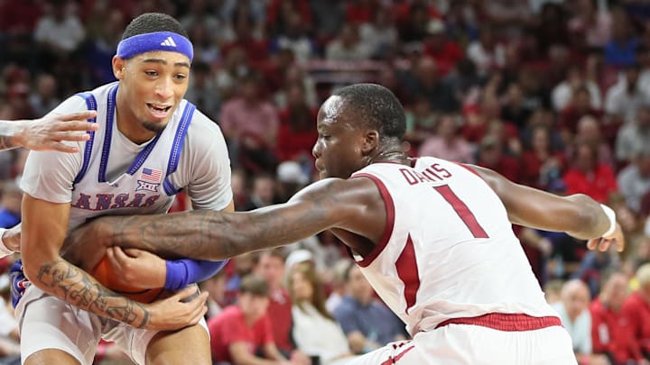 Arkansas Razorbacks guard Nelly Davis (1) provides harassing help defense against Kansas Jayhawks guard Dajuan Harris Jr. (3) as he drives into the paint during their exhibition game at Bud Walton Arena.