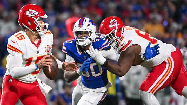 Nov 17, 2024; Orchard Park, New York, USA; Kansas City Chiefs quarterback Patrick Mahomes (15) is pressured by Buffalo Bills defensive end Greg Rousseau (50) who's being blocked by guard Trey Smith (65) in the third quarter at Highmark Stadium. Mandatory Credit: Mark Konezny-Imagn Images