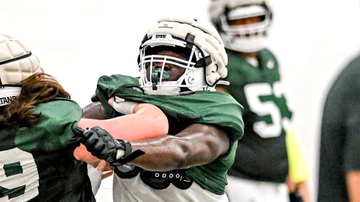 Michigan State's Rakeem Johnson, right, and Jacob Merritt run a drill during camp on Monday, Aug. 5, 2024, at the indoor practice facility in East Lansing.