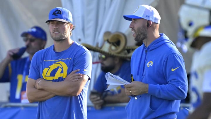 Jul 29, 2024; Los Angeles, CA, USA; Los Angeles Rams quarterback Matthew Stafford (9) talks with quarterback coach Dave Ragone during training camp at Loyola Marymount University. Mandatory Credit: Jayne Kamin-Oncea-Imagn Images