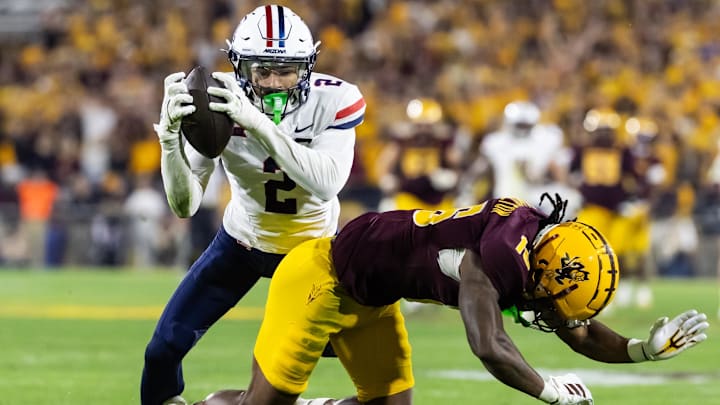 Nov 28, 2025; Tempe, Arizona, USA; Arizona Wildcats defensive back Treydan Stukes (2) intercepts the ball against Arizona State Sun Devils wide receiver Jaren Hamilton (16) in the second half during the 99th Territorial Cup at Mountain America Stadium. Mandatory Credit: Mark J. Rebilas-Imagn Images