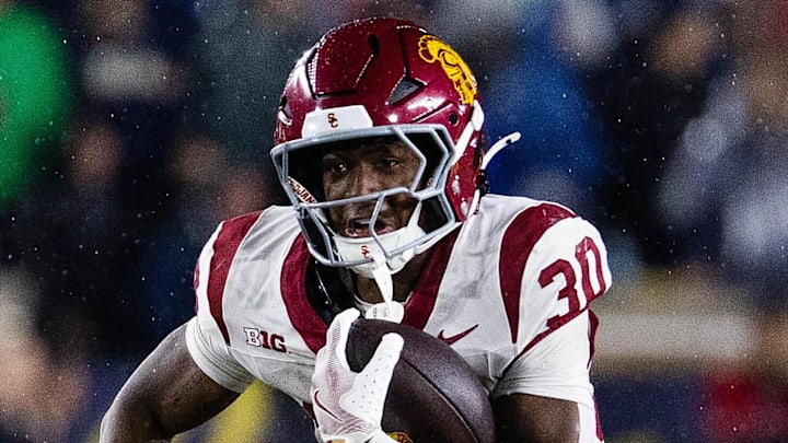 Oct 18, 2025; South Bend, Indiana, USA; Southern California Trojans running back King Miller (30) runs the ball while Notre Dame Fighting Irish safety Tae Johnson (9) defends in the second half at Notre Dame Stadium. Mandatory Credit: Trevor Ruszkowski-Imagn Images