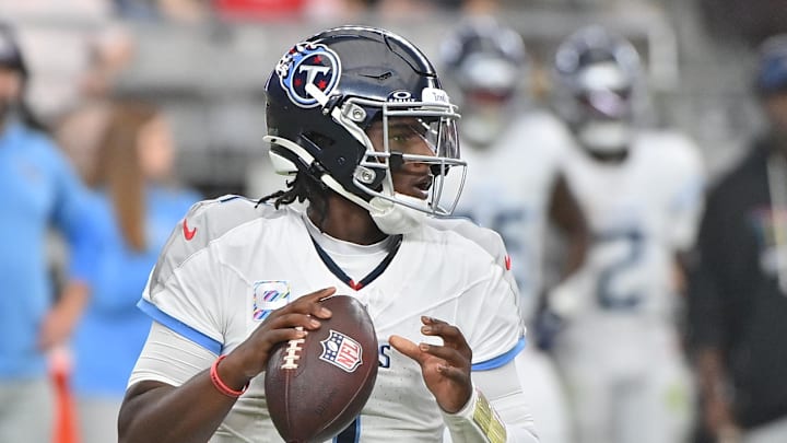 Oct 5, 2025; Glendale, Arizona, USA; Tennessee Titans quarterback Cam Ward (1) looks to throw against the Arizona Cardinals during the fourth quarter at State Farm Stadium. Mandatory Credit: Matt Kartozian-Imagn Images