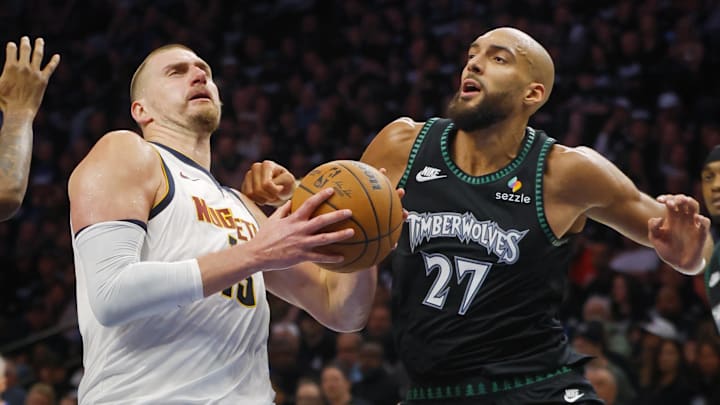 Apr 23, 2026; Minneapolis, Minnesota, USA; Denver Nuggets center Nikola Jokic (15) goes to the basket against Minnesota Timberwolves center Rudy Gobert (27) in the third quarter at Target Center.