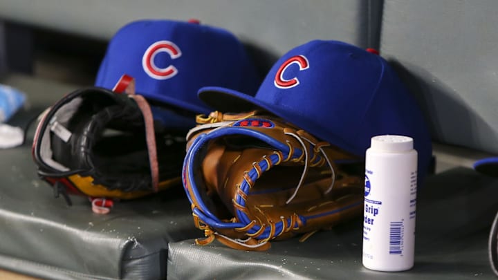 Chicago Cubs hats and gloves in the dugout