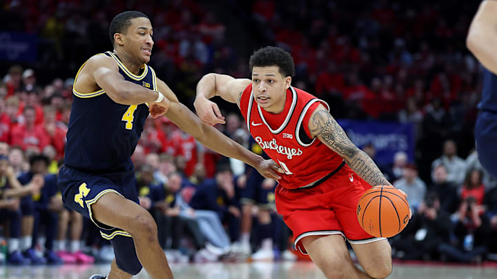 Feb 16, 2025; Columbus, Ohio, USA;  Ohio State Buckeyes guard John Mobley Jr. (0) drives with the ball as Michigan Wolverines guard Nimari Burnett (4) defends during the second half at Value City Arena. Mandatory Credit: Joseph Maiorana-Imagn Images