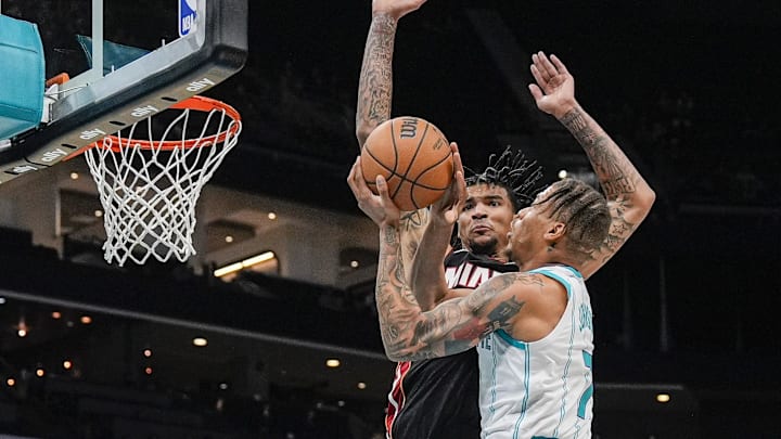 Charlotte Hornets forward Keyontae Johnson (7) blocked by Miami Heat center Kel'el Ware (7) at the Spectrum Center. Charlotte Hornets forward Keyontae Johnson (7) blocked by Miami Heat center Kel'el Ware (7) at the Spectrum Center.