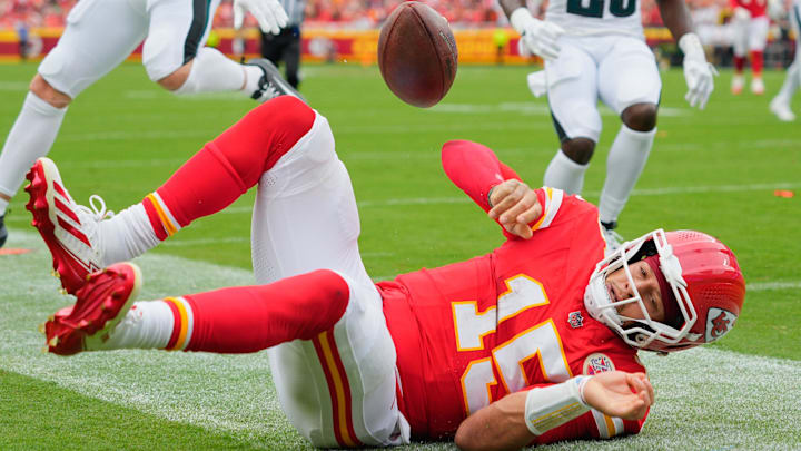 Sep 14, 2025; Kansas City, Missouri, USA; Kansas City Chiefs quarterback Patrick Mahomes (15) scores a touchdown defended by Philadelphia Eagles defensive end Za'Darius Smith (52) and cornerback Jakorian Bennett (23) during the second quarter of the game at GEHA Field at Arrowhead Stadium. Mandatory Credit: Jay Biggerstaff-Imagn Images