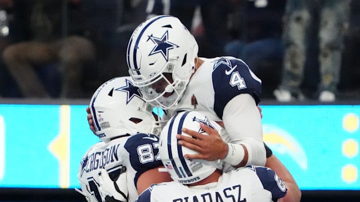 Dallas Cowboys quarterback Dak Prescott celebrates with teammates after scoring a touchdown against the Los Angeles Chargers 