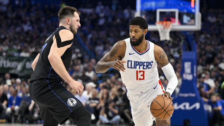 May 3, 2024; Dallas, Texas, USA; LA Clippers forward Paul George (13) moves the ball past Dallas Mavericks guard Luka Doncic (77) during the first quarter during game six of the first round for the 2024 NBA playoffs at American Airlines Center. Mandatory Credit: Jerome Miron-USA TODAY Sports