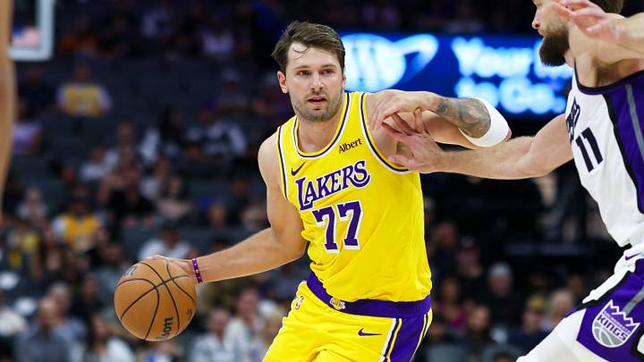 Oct 5, 2026; Sacramento, California, USA;  Los Angeles Lakers guard Luka Doncic (77) drives with the ball against Sacramento Kings forward Domantas Sabonis (11) during the first quarter at Golden 1 Center.  Mandatory Credit: Sergio Estrada-Imagn Images