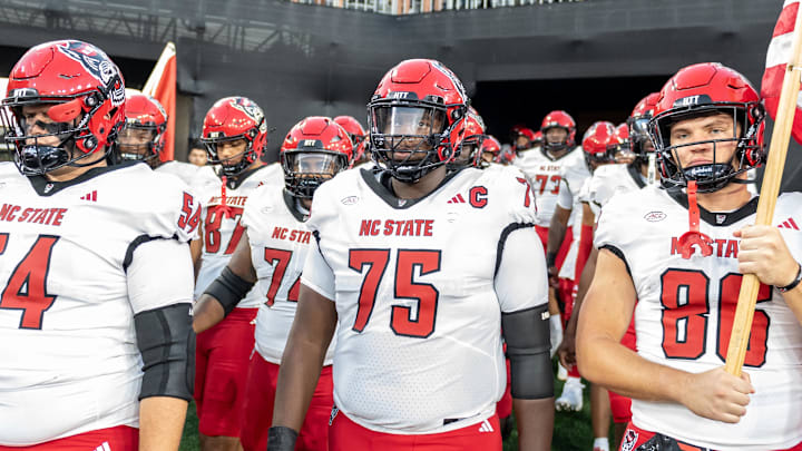 Sep 11, 2025; Winston-Salem, North Carolina, USA;  North Carolina State Wolfpack enter the field against for a game against the Wake Forest Demon Deacons at Allegacy Federal Credit Union Stadium. Mandatory Credit: Luke Jamroz-Imagn Images