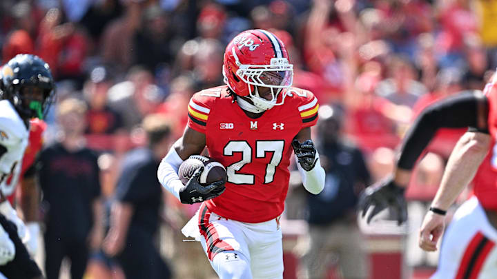 Sep 13, 2025; College Park, Maryland, USA;  Maryland Terrapins defensive back La'khi Roland (27) begins a 100-yard interception return for a touchdown in his own end zone in the second half against the Towson Tigers at SECU Stadium. Mandatory Credit: Jamie Sabau-Imagn Images