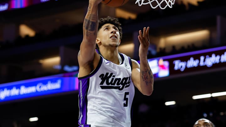 Oct 15, 2025; Sacramento, California, USA; Sacramento Kings guard Nique Clifford (5) drives to the basket against Los Angeles Clippers forward Kawhi Leonard (2) during the second quarter at Golden 1 Center. Mandatory Credit: Sergio Estrada-Imagn Images