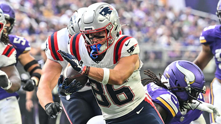 Aug 16, 2025; Minneapolis, Minnesota, USA; New England Patriots wide receiver Efton Chism III (86) scores a touchdown as center Jared Wilson (58) looks on during the second quarter at U.S. Bank Stadium. Mandatory Credit: Jeffrey Becker-Imagn Images