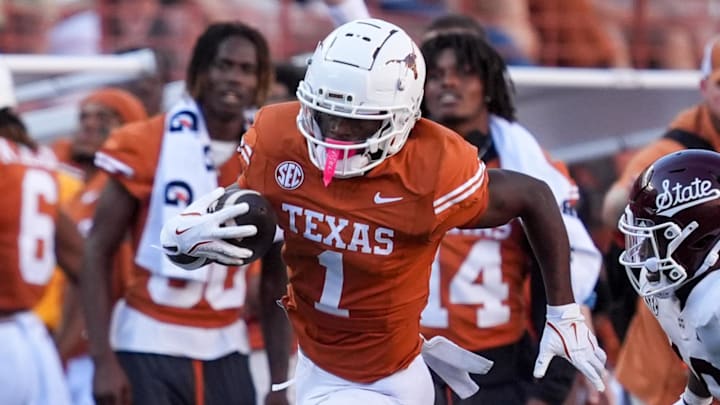 Sep 28, 2024; Austin, Texas, USA;  Texas Longhorns wide receiver Johntay Cook II (1) runs from Mississippi State Bulldogs safety Corey Ellington (10) in the second half at Darrell K Royal-Texas Memorial Stadium. Mandatory Credit: Daniel Dunn-Imagn Images