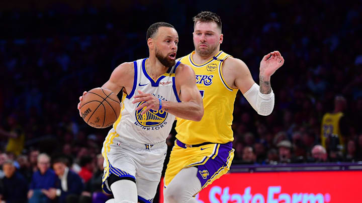 Apr 3, 2025; Los Angeles, California, USA; Golden State Warriors guard Stephen Curry (30) moves to the basket against Los Angeles Lakers guard Luka Doncic (77) during the second half at Crypto.com Arena. Mandatory Credit: Gary A. Vasquez-Imagn Images