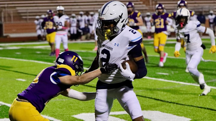 OLSH 's Talen Ellis (11) makes a tackle on Bishop Canevin's Jason Cross (2) in Friday night s game at Tiger Stadium. OLSH 's Talen Ellis (11) makes a tackle on Bishop Canevin's Jason Cross (2) in Friday night s game at Tiger Stadium.