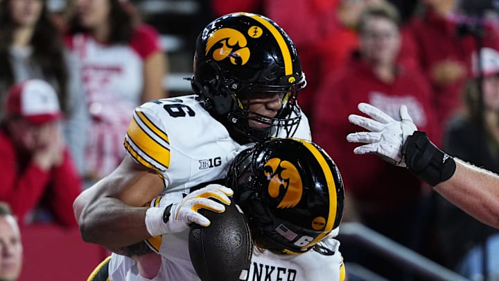 Oct 11, 2025; Madison, Wisconsin, USA; Iowa Hawkeyes running back Xavier Williams (26) celebrates a touchdown with teammate offensive lineman Gennings Dunker (67) during the second half against the Wisconsin Badgers at Camp Randall Stadium. Mandatory Credit: Ross Harried-Imagn Images