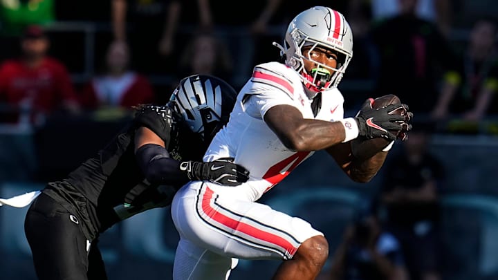 Oct 12, 2024; Eugene, Oregon, USA; Ohio State Buckeyes wide receiver Jeremiah Smith (4) catches a pass and is tackled by Oregon Ducks defensive back Brandon Johnson (3) during the first half of the NCAA football game at Autzen Stadium Oct 12, 2024; Eugene, Oregon, USA; Ohio State Buckeyes wide receiver Jeremiah Smith (4) catches a pass and is tackled by Oregon Ducks defensive back Brandon Johnson (3) during the first half of the NCAA football game at Autzen Stadium