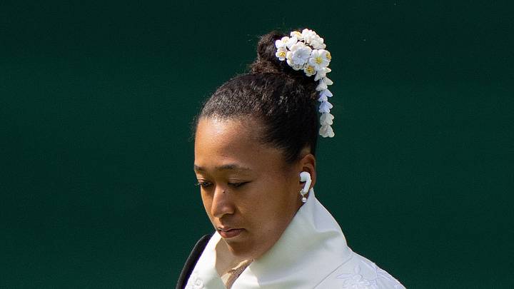 Naomi Osaka enters the court in her Japanese-inspired ceremonial dress