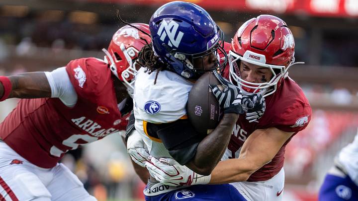 Arkansas Razorbacks linebacker Ben Bogle tackles a UNA offensive player during the season opener.