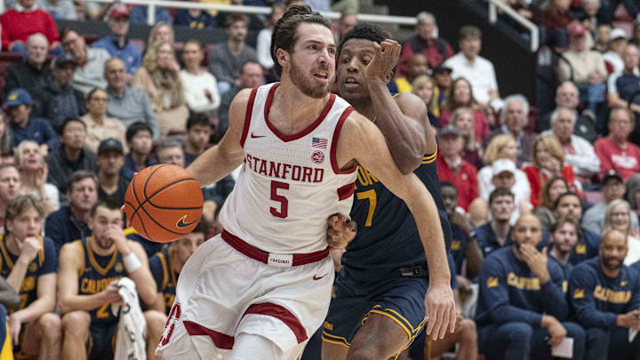 Jan 24, 2026; Stanford, California, USA;  Stanford Cardinal guard Benny Gealer (5) drives the ball during the first half against California Golden Bears guard Dai Dai Ames (7) at Maples Pavilion. Mandatory Credit: Stan Szeto-Imagn Images