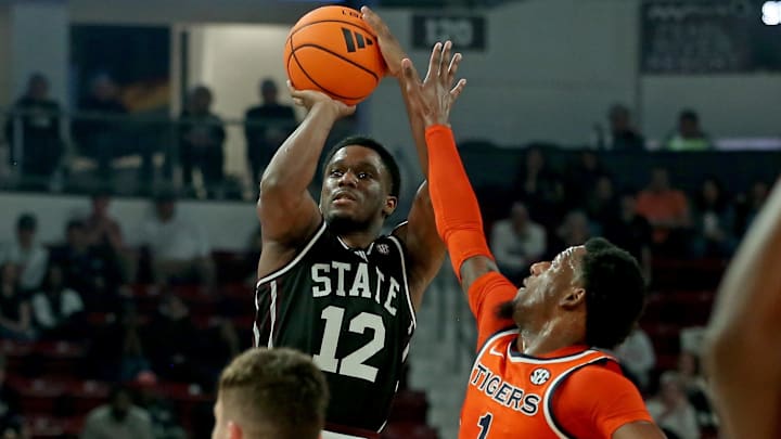 Mississippi State Bulldogs guard Josh Hubbard (12) shoots for three as Auburn Tigers guard/forward Kevin Overton (1) defends during the second half at Humphrey Coliseum.