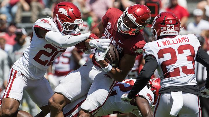 Arkansas Razorbacks wide receiver Antonio Jordan (19) is tackled by defensive back Jahiem Johnson (20) and defensive back Ian Williams (23) during the spring game at Razorback Stadium. Arkansas Razorbacks wide receiver Antonio Jordan (19) is tackled by defensive back Jahiem Johnson (20) and defensive back Ian Williams (23) during the spring game at Razorback Stadium.