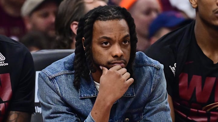 Cleveland Cavaliers guard Darius Garland watches a playoff game from the bench.