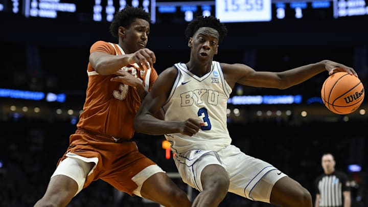 BYU Cougars forward AJ Dybantsa (3) dribbles against Texas Longhorns forward Dailyn Swain (3) in the second half during a first round game of the men's 2026 NCAA Tournament at Moda Center. Mandatory Credit: Troy Wayrynen-Imagn Images
