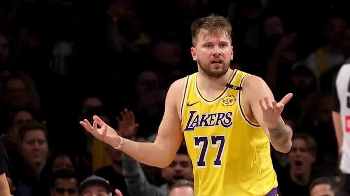 Mar 10, 2025; Brooklyn, New York, USA; Los Angeles Lakers guard Luka Doncic (77) reacts towards referee Ray Acosta (54) during the fourth quarter against the Brooklyn Nets at Barclays Center. Mandatory Credit: Brad Penner-Imagn Images